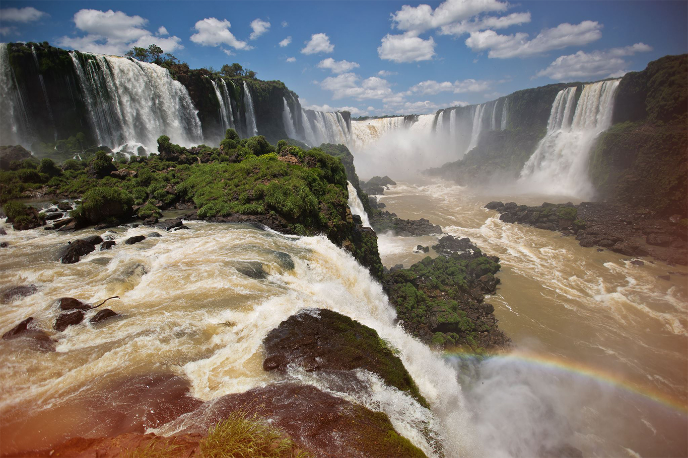 <p>Photo courtesy G Adventures’ own <a href="https://twitter.com/gadv_oanadragan/">Oana Dragan</a>.</p> The roaring Iguassu Falls with added rainbow bordering Brazil and Argentina