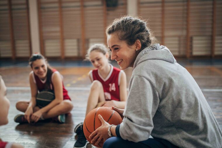 Basketball coach talking to players