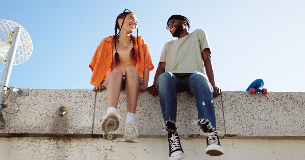 People sitting on wall laughing and smiling